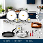 Collection of stainless steel kitchen utensils and cookware on a white surface with a kitchen background.