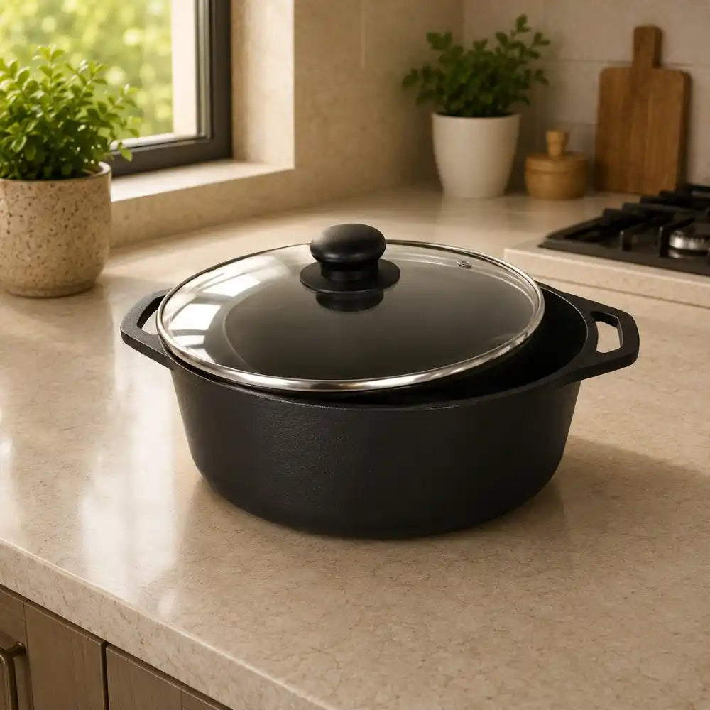 Black cast iron cookware with glass lid on a kitchen counter