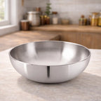 Hindalium aluminium kadai without handle placed on kitchen countertop, polished aluminium cooking vessel.