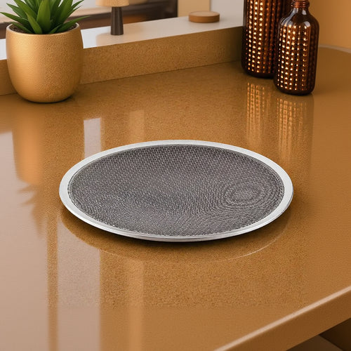 Round gray mat with textured surface on a brown surface