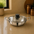 Stainless steel pot with lid on a beige surface