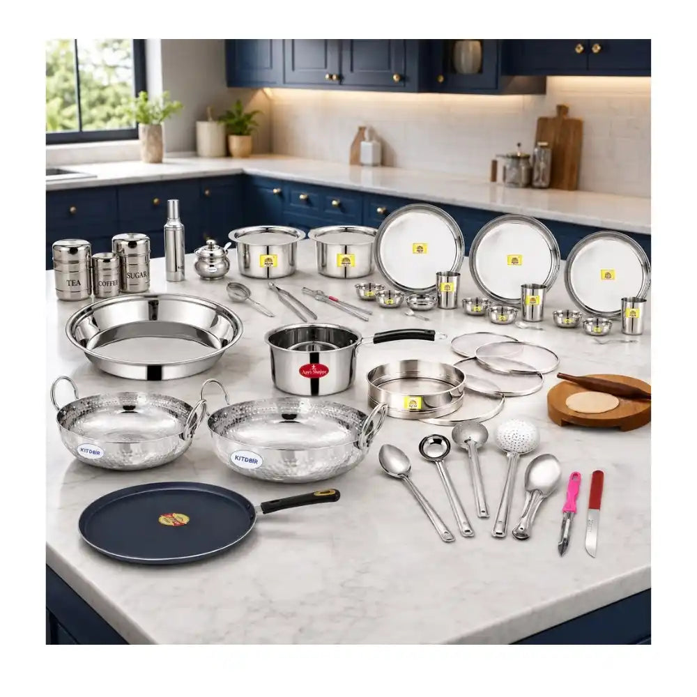 Set of stainless steel cookware and kitchen utensils on a kitchen counter.