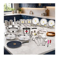 Set of stainless steel cookware and kitchen utensils on a kitchen counter.