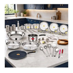Set of stainless steel cookware and kitchen utensils on a kitchen counter.