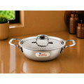Stainless steel pot with lid on a reflective surface, featuring the 'Em Rajesh' brand.