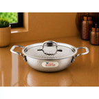 Stainless steel pot with lid on a reflective surface, featuring the 'Em Rajesh' brand.