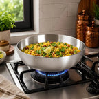 Stir-fry dish in a large metal bowl on a gas stove with a kitchen background