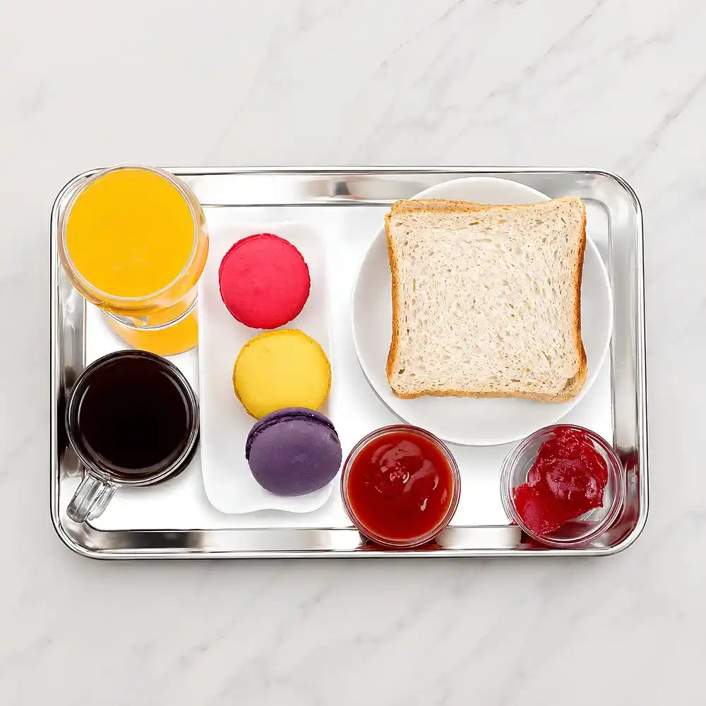 Tray with bread, macarons, and small containers of food on a white surface