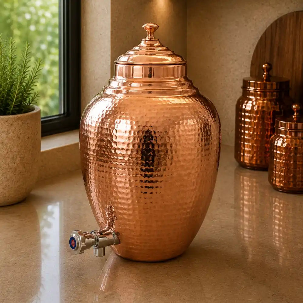 Copper dispenser jug with a plant and mirror in the background