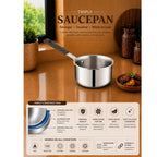 A stainless steel triply constructed saucepan with a long handle, shown on a warm brown countertop in a kitchen scene. The image includes marketing text and feature icons below, highlighting its triple-wall construction, premium quality, and suitability for gas, induction, electric, and ceramic cooktops.