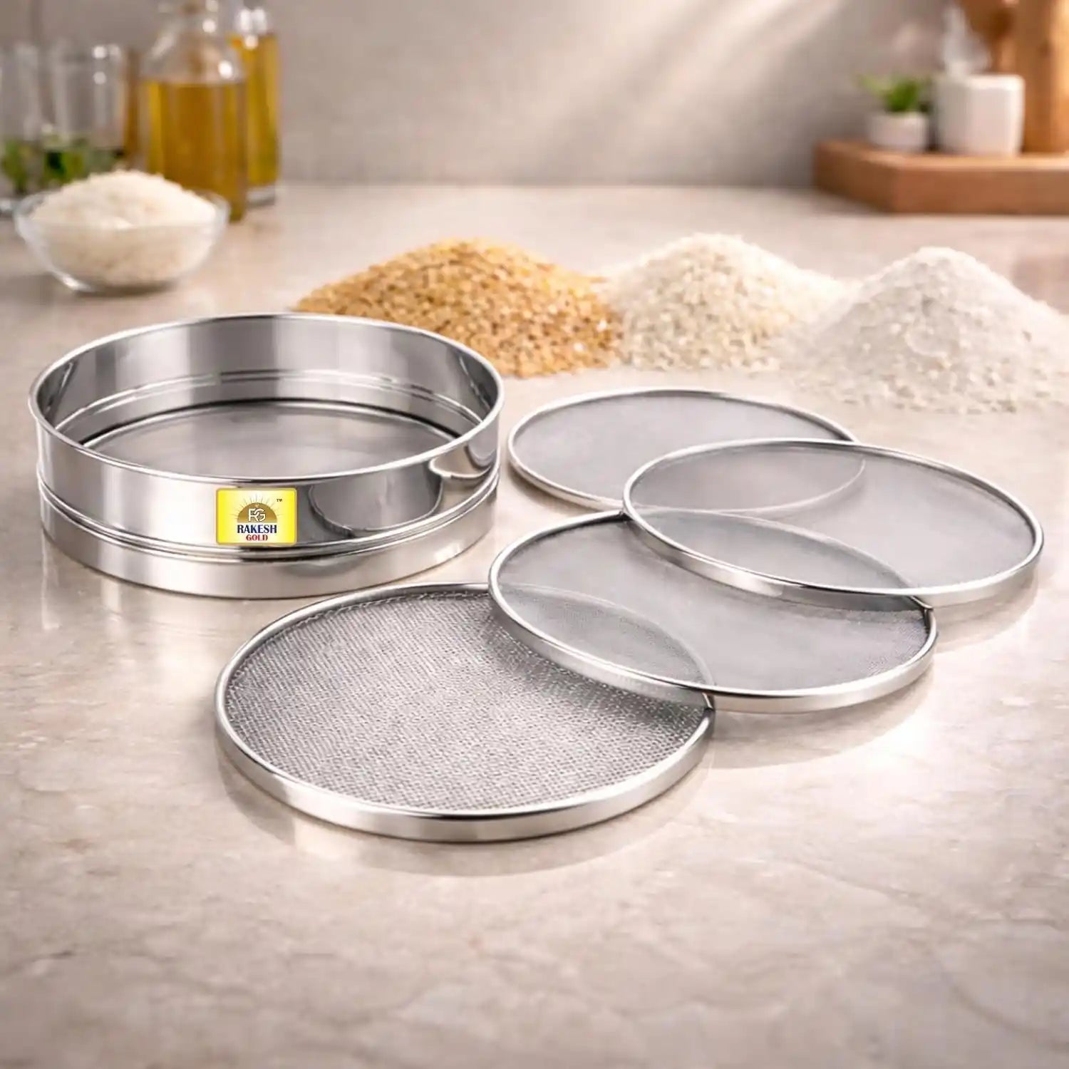 4-in-1 stainless steel chalni (flour sieve) set with interchangeable mesh screens on a modern kitchen countertop, ideal for sifting flour, atta, maida, and grains.