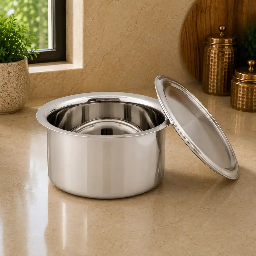 Stainless steel pot with lid on a beige countertop