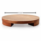A round wooden riser or platform with a warm medium-brown wood finish, shown on a white background with a black dimension line indicating a 9-inch width.