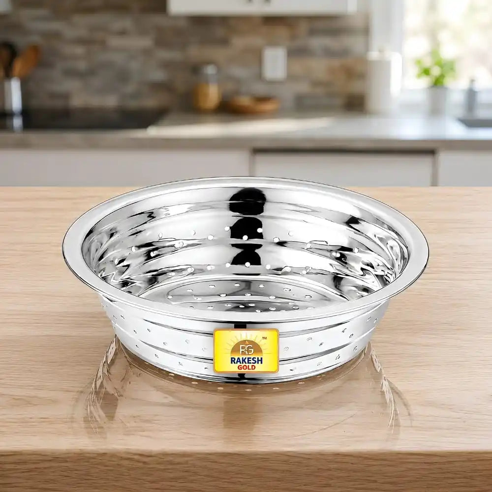 Stainless steel vegetable washing chalni with perforated design on a modern kitchen countertop, ideal for rinsing fruits, vegetables, rice, and pasta.