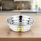 Stainless steel vegetable washing chalni with perforated design on a modern kitchen countertop, ideal for rinsing fruits, vegetables, rice, and pasta.