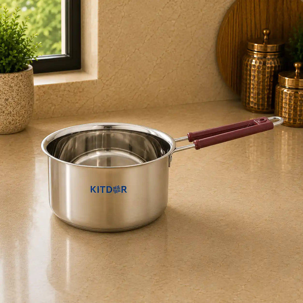 Stainless steel pot with maroon handle on a beige countertop, featuring the KITDR brand.