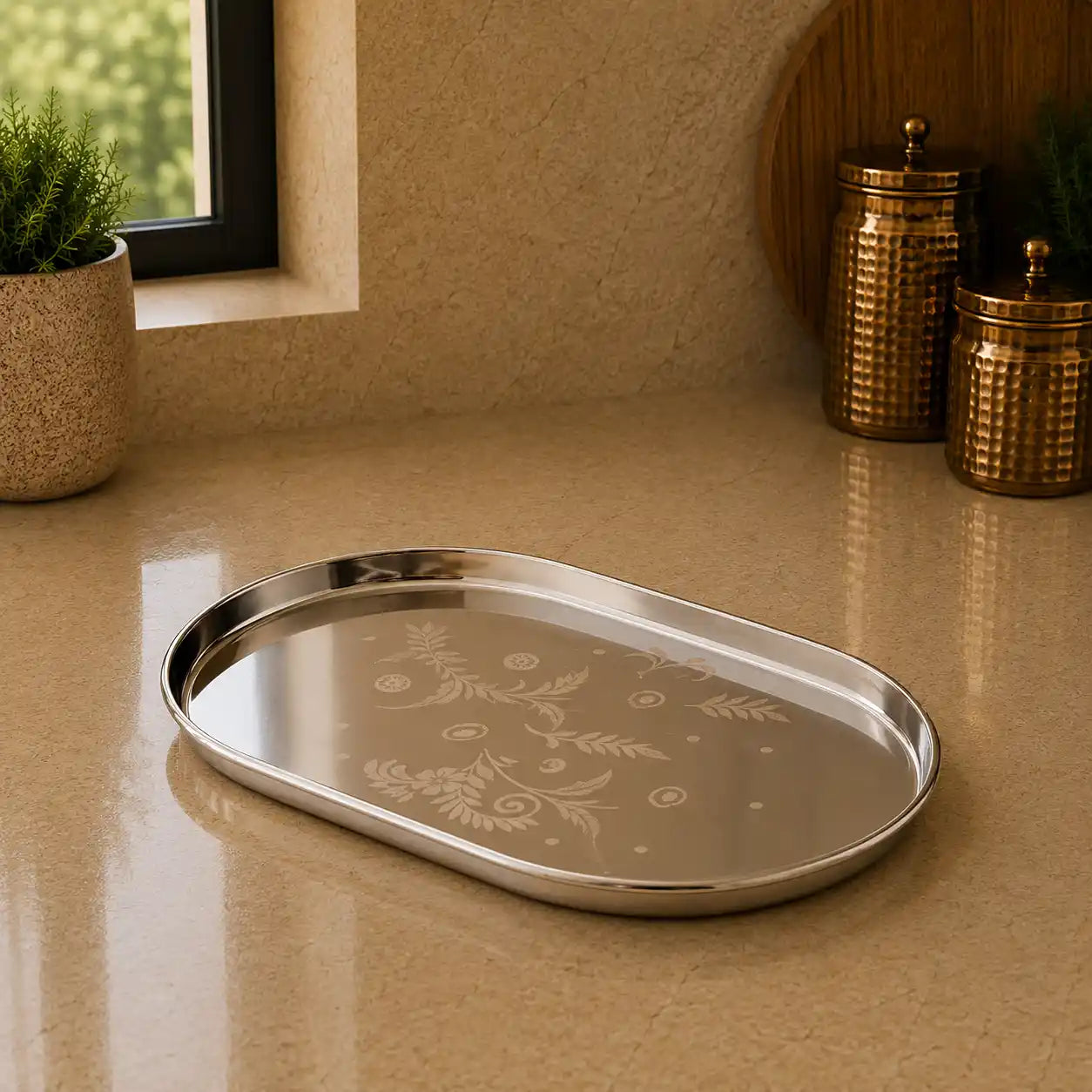 Silver tray with floral patterns on a beige surface