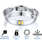 Stainless steel chalni (strainer) on a warm modern kitchen countertop with a window view, decorative plant, and copper storage jars.