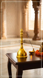 Gold bell on a wooden table with a blurred background