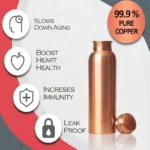 Pure copper water bottle on marble countertop with tulsi leaves and lemon slices in warm kitchen lighting