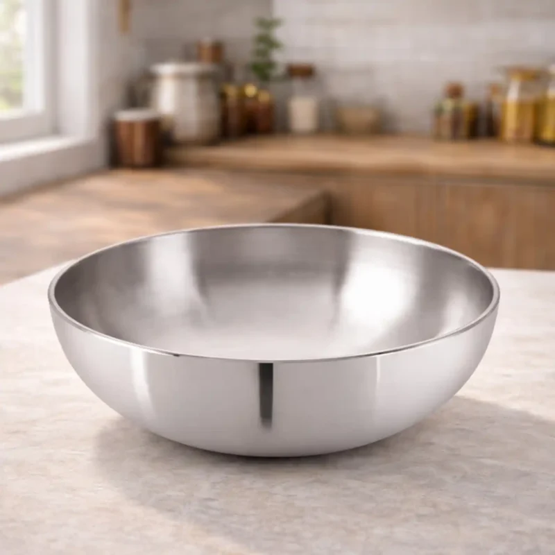 Hindalium aluminium kadai without handle placed on kitchen countertop, polished aluminium cooking vessel.