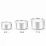 Three stainless steel tope cooking vessels set with capacities 0.4L, 0.8L and 1.2L on white background