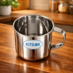 Stainless Steel Mug with Handle filled with ice water on wooden table in kitchen